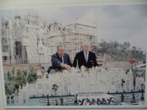 One of the images of Walt looking over the model of Small World during construction.