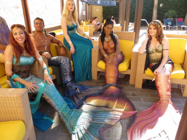 Mermaids and merman at the pool party